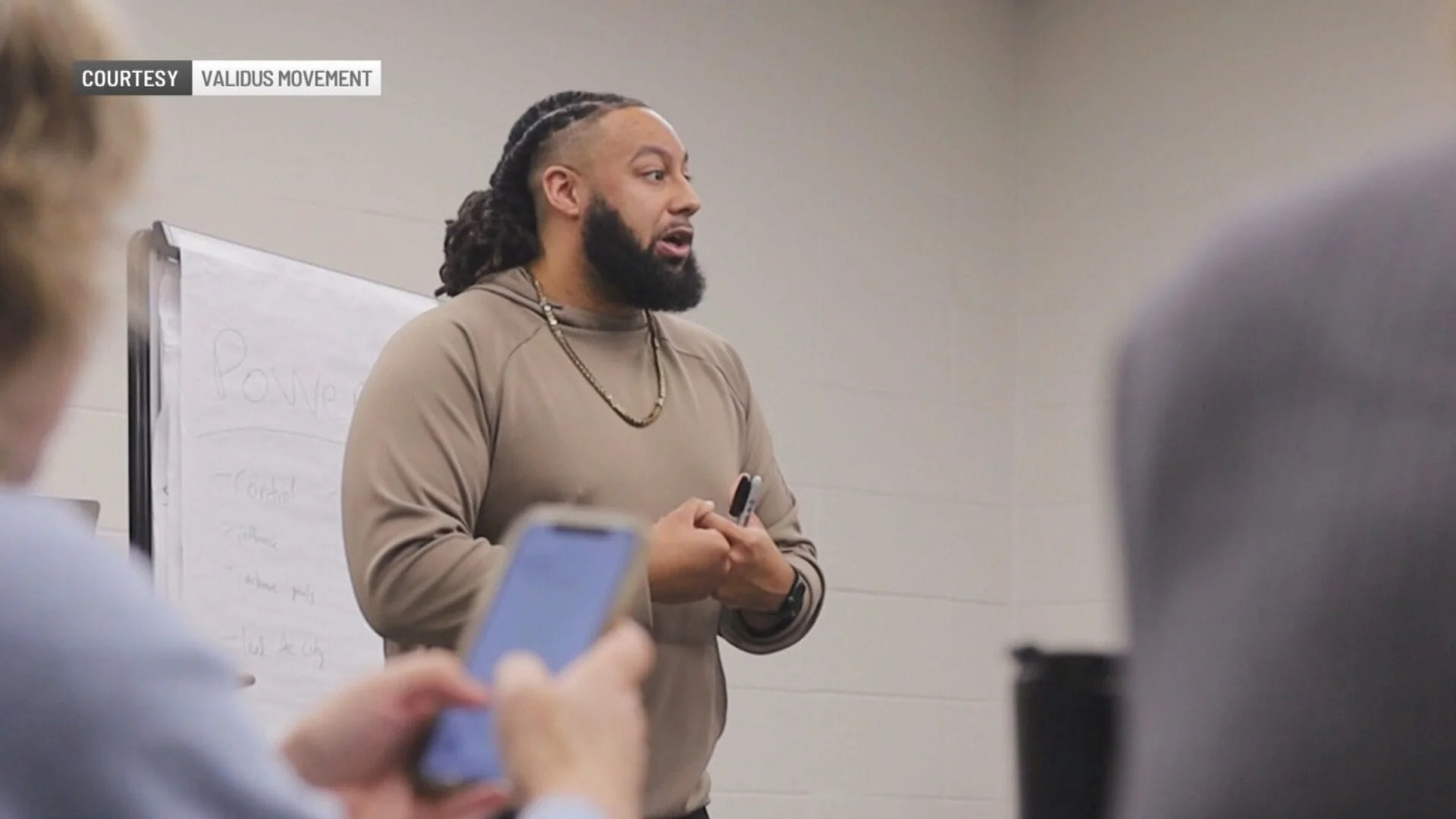 Josh Riddick, founder of The Validus Movement, speaking at a community event